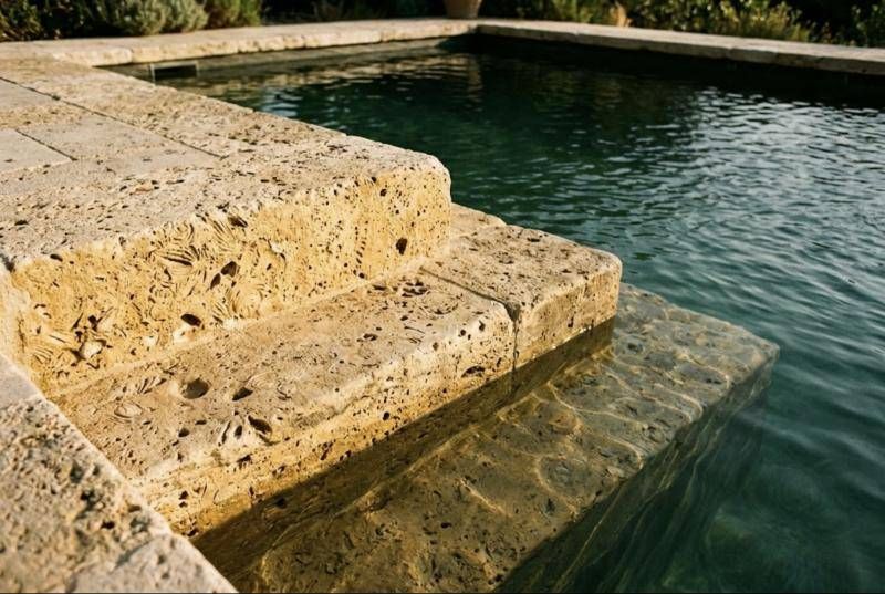 Marches d'entrée de piscine en pierre de Rognes blonde, fossiles et coquillages visibles dans la pierre